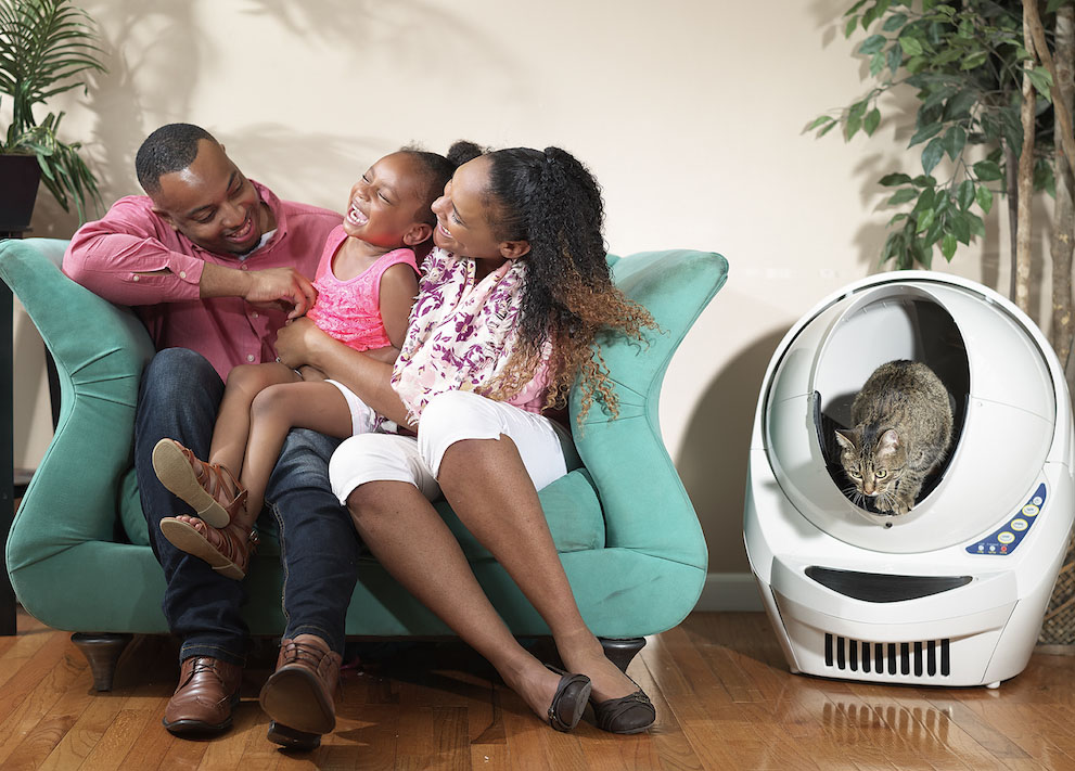 happy family next to automatic cat litter box