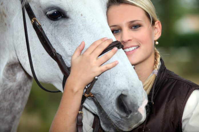 smiling woman with a horse