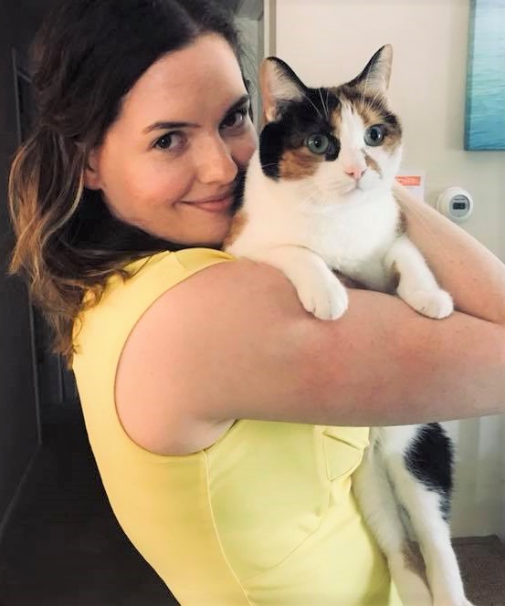 Jessica and her calico cat Abby that she feeds using an electronic cat feeder