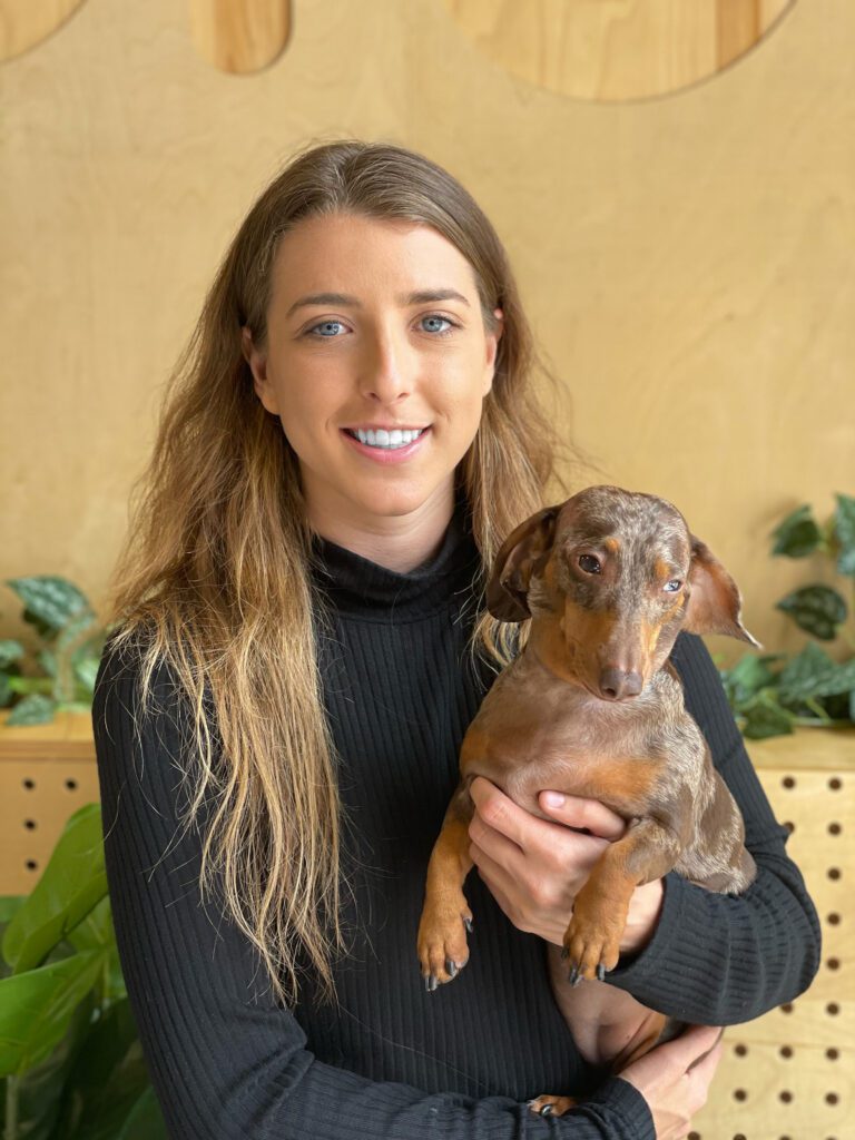 Shaina Denny Founder of Dogdrop and Poppy her mini chocolate dapple dachshund dog